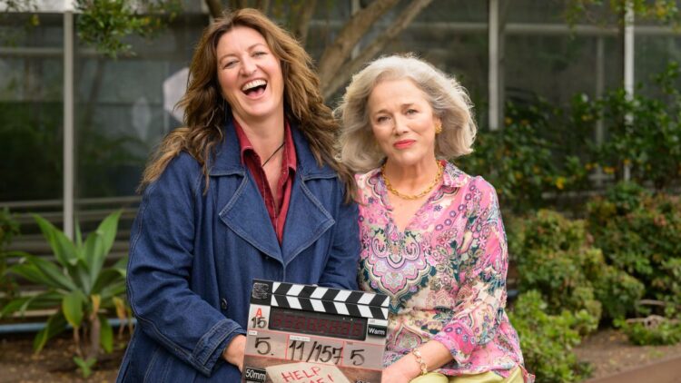 Kate Box and Sarah Peirse holding a Help Me! clapperboard in Sydney