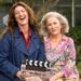 Kate Box and Sarah Peirse holding a Help Me! clapperboard in Sydney