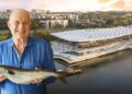 Rick Stein holding a fish in front of the new Sydney Fish Market