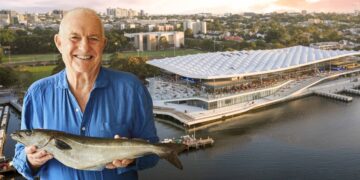 Rick Stein holding a fish in front of the new Sydney Fish Market