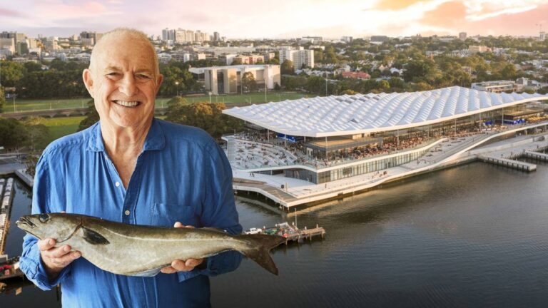 Rick Stein holding a fish in front of the new Sydney Fish Market