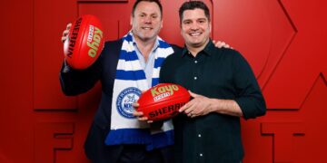 David King and Leigh Montagna hold Kayo Sports footballs ahead of the 2027 AFL season.
