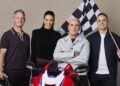 10's MotoGP commentary team Cameron Donald, Tara Rushton, Daryl Beattie and Sam Charlwood with a Honda motorcycle and chequered flag