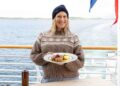 Justine Schofield holds a Norwegian dish aboard a Hurtigruten ship in Norway Gourmet