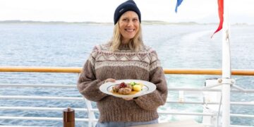 Justine Schofield holds a Norwegian dish aboard a Hurtigruten ship in Norway Gourmet