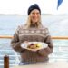 Justine Schofield holds a Norwegian dish aboard a Hurtigruten ship in Norway Gourmet