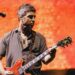 Noel Gallagher playing guitar during the Oasis reunion tour