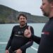 Colin Fassnidge and Manu Feildel in wetsuits on a boat in Akaroa for Off the Grid with Colin and Manu