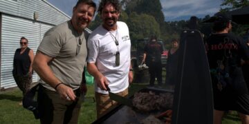 Colin Fassnidge and Manu Feildel cooking at an outdoor grill in Off the Grid on Channel 7