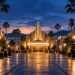 Illuminated film studio lot at dusk, representing the Paramount and Warner Bros. Discovery merger