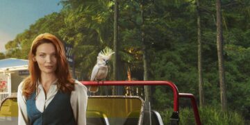 Anna Samson as Mackenzie Clarke beside a red vehicle and cockatoo in Return to Paradise season three