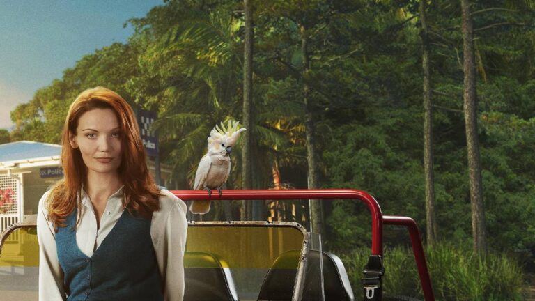 Anna Samson as Mackenzie Clarke beside a red vehicle and cockatoo in Return to Paradise season three