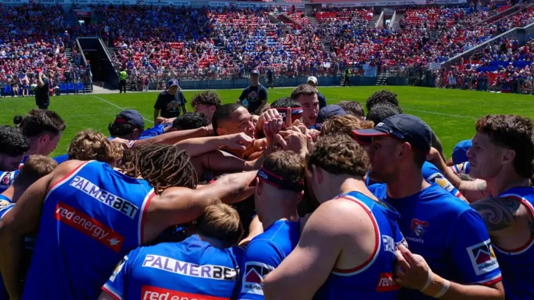 Newcastle Knights players gather in a team huddle
