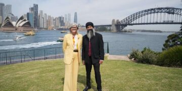 Governor-General Sam Mostyn and Sukhdeep Singh Bhogal standing beside Sydney Harbour