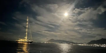 A yacht under storm clouds at sea