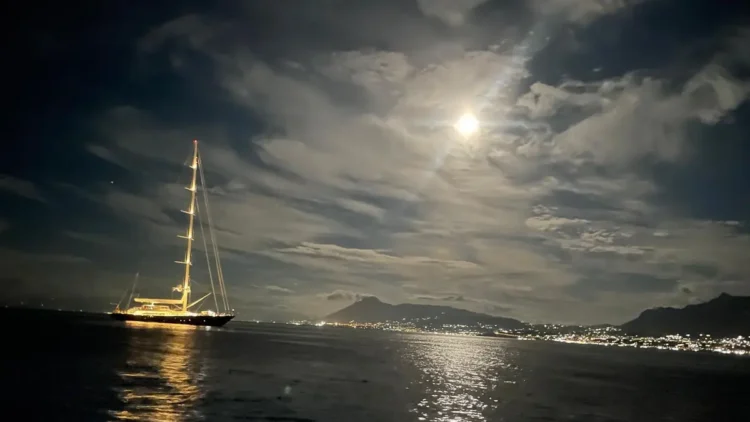 A yacht under storm clouds at sea