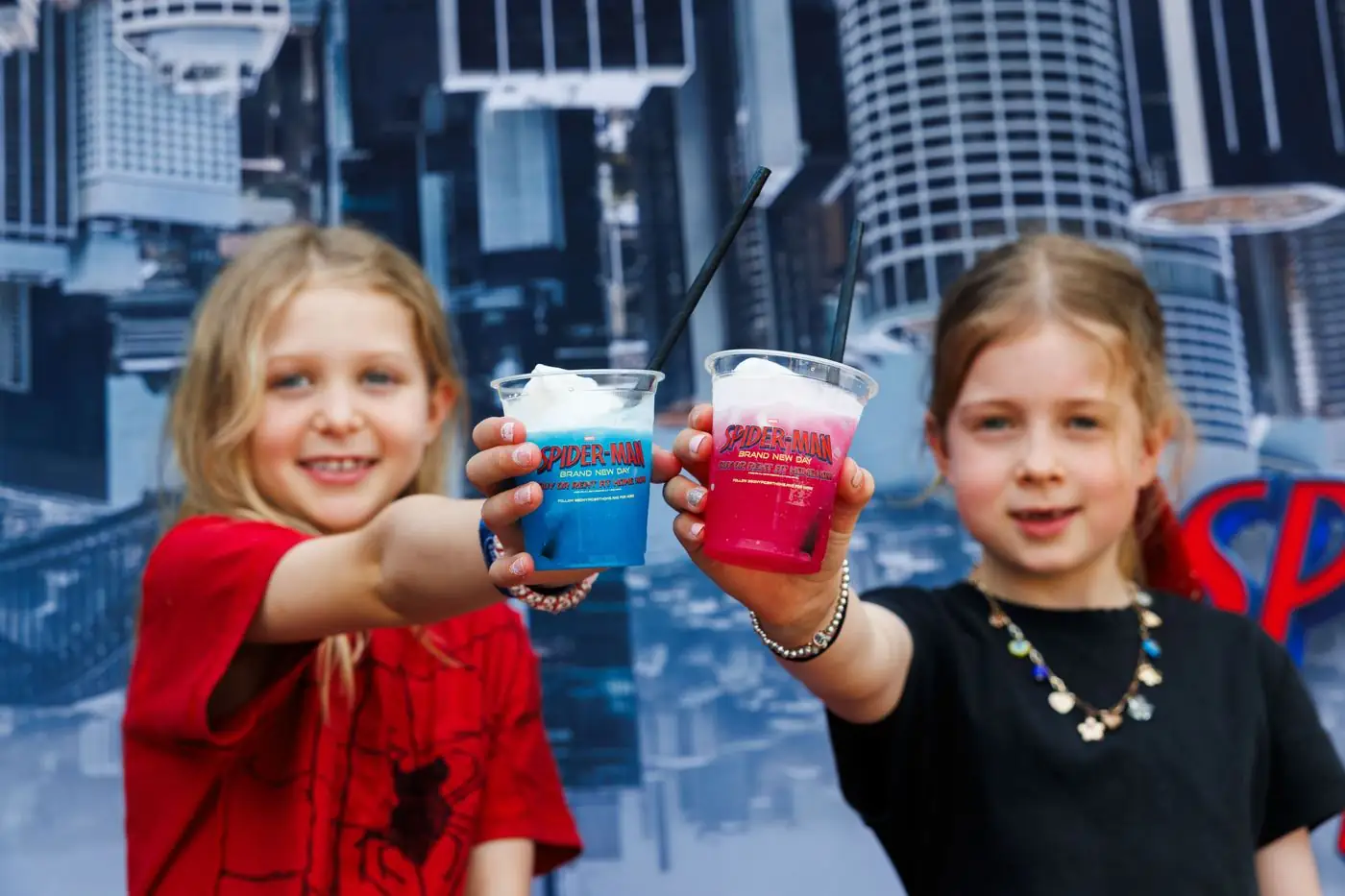 Two young fans show their Spider drinks at the Sydney Spider-Man event
