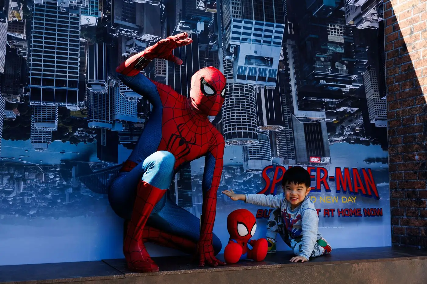 Spider-Man poses with a young fan at the Circular Quay event