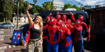 Spider-Man fans take a group selfie at the Circular Quay fan event in Sydney