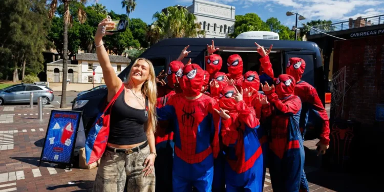Spider-Man fans take a group selfie at the Circular Quay fan event in Sydney