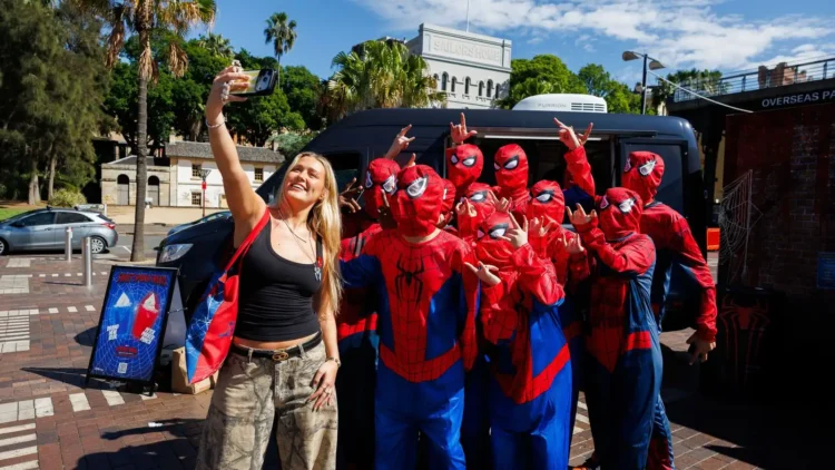 Spider-Man fans take a group selfie at the Circular Quay fan event in Sydney