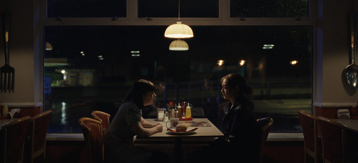 Daisy and Rhiannon sit together in a diner in Sweetpea Season 2.
