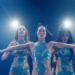 Three dancers in sequinned blue costumes perform under stage lights in The Body on Netflix