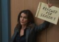 Keri Russell holds a Renewed for Season 5 sign for The Diplomat on Netflix