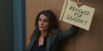 Keri Russell holds a Renewed for Season 5 sign for The Diplomat on Netflix
