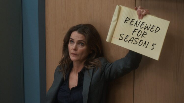 Keri Russell holds a Renewed for Season 5 sign for The Diplomat on Netflix