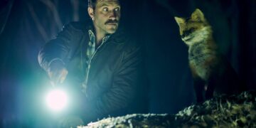 Jai Courtney beside the fox in an official still from The Fox