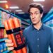 Craig Reucassel holds a bundle of sausages rigged like a bomb in a supermarket aisle for The Great Food Con on ABC