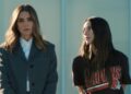 Two characters in Disney+ drama The Land stand together, one wearing a Cleveland Browns shirt