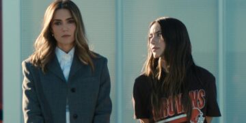 Two characters in Disney+ drama The Land stand together, one wearing a Cleveland Browns shirt