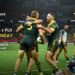 Australia and Fiji players after a try on a Sunday TV ratings card stating Australia v Fiji leads with 3.020 million Total TV reach and Seven wins with 37.7% share.