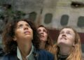 Yellowjackets survivors look upwards beside the crashed plane in season four