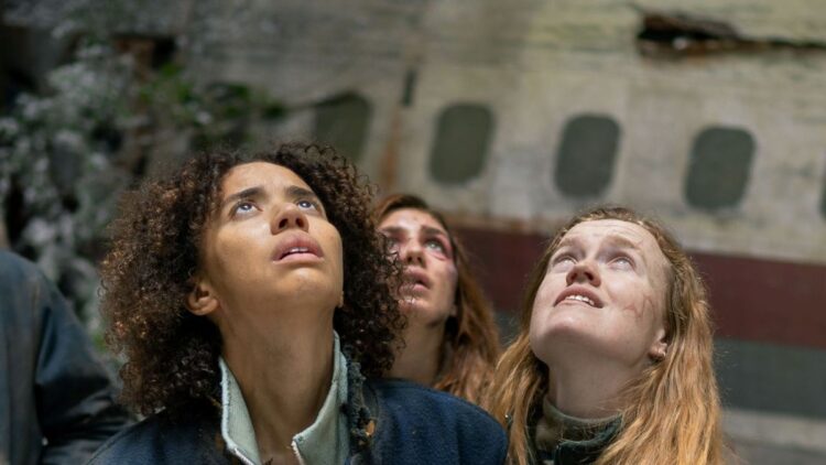 Yellowjackets survivors look upwards beside the crashed plane in season four