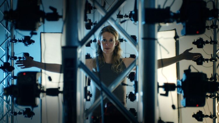 Elizabeth Holmes surrounded by cameras in You Can See Everything